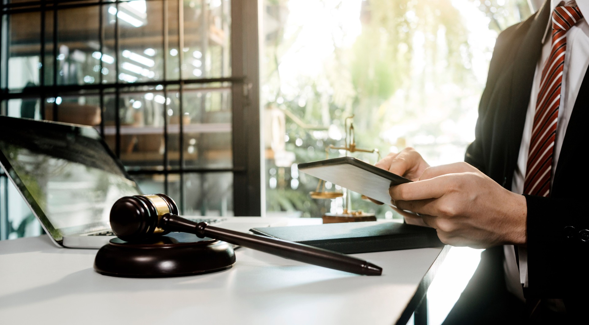 Business and lawyers discussing contract papers with brass scale on desk in office. Law, legal services, advice, justice and law concept picture with film grain effect